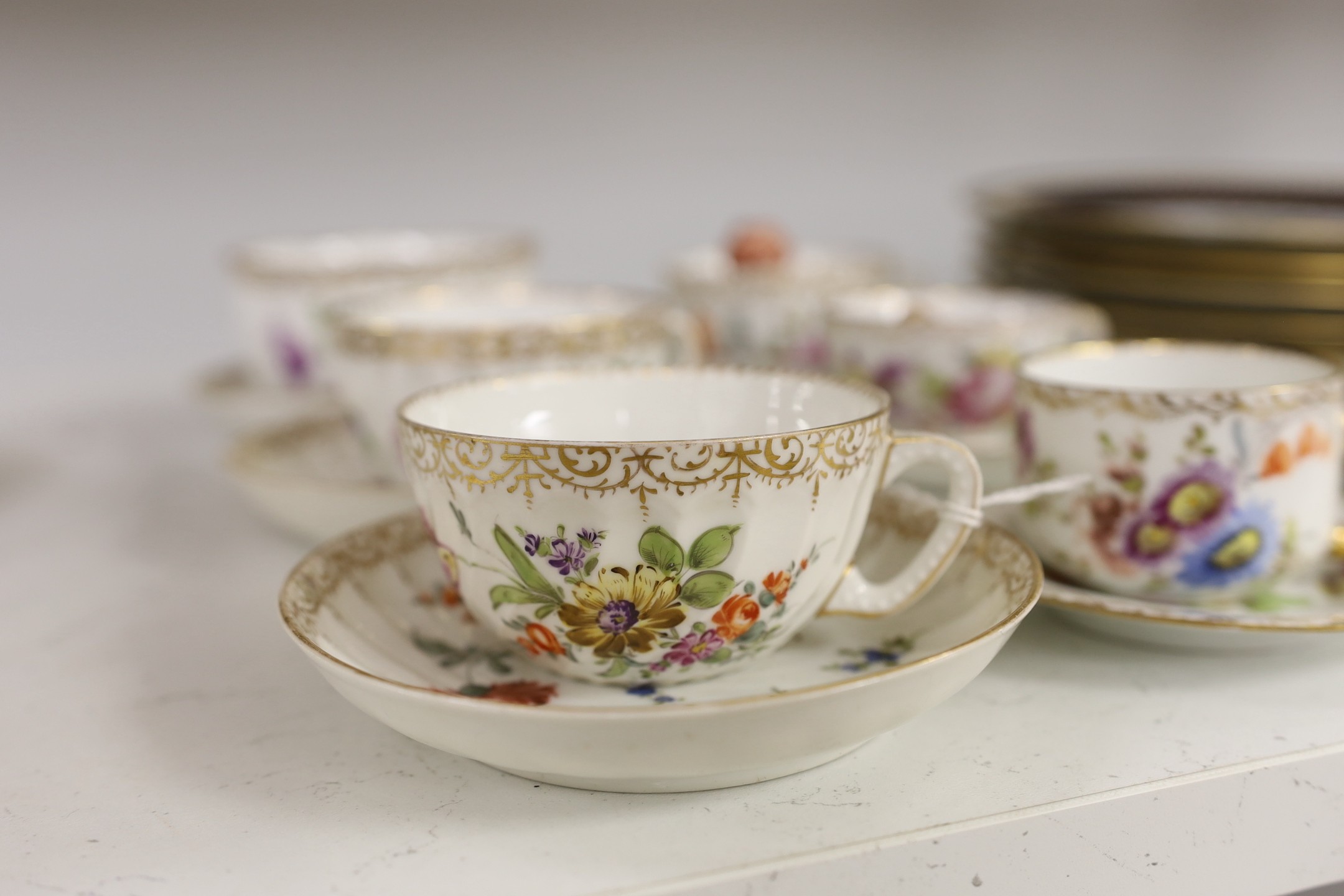 A group of Dresden floral cups and saucers, and five jewelled cabinet plates, etc.